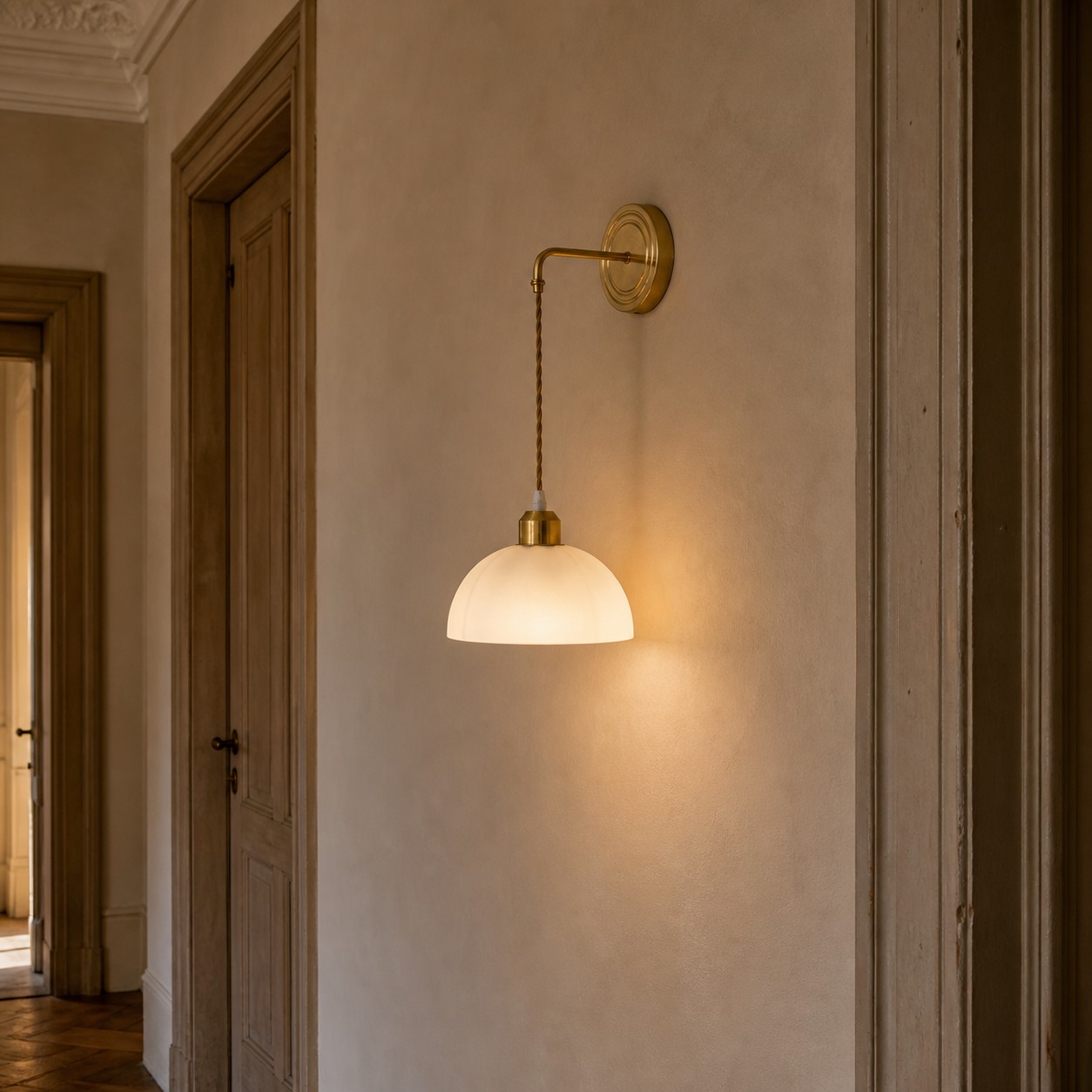Scalloped shade copper and glass wall sconce in a dining area