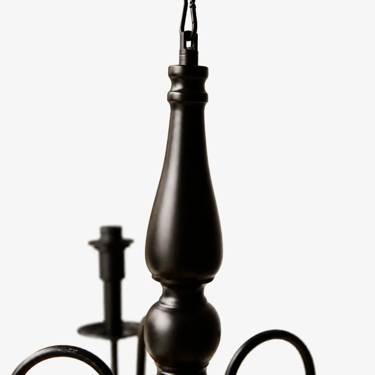 Close view of the black turned center column and hanging chain
