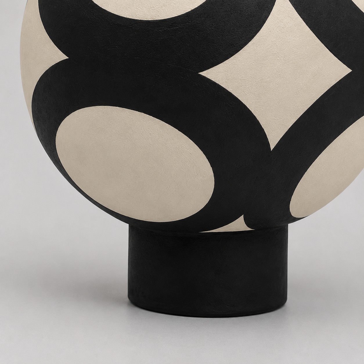 round ceramic body and black base detail